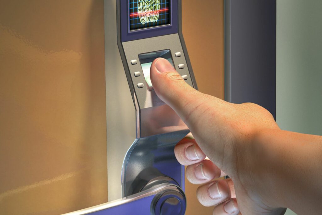 A person uses a finger scanner to get past a biometric security system.